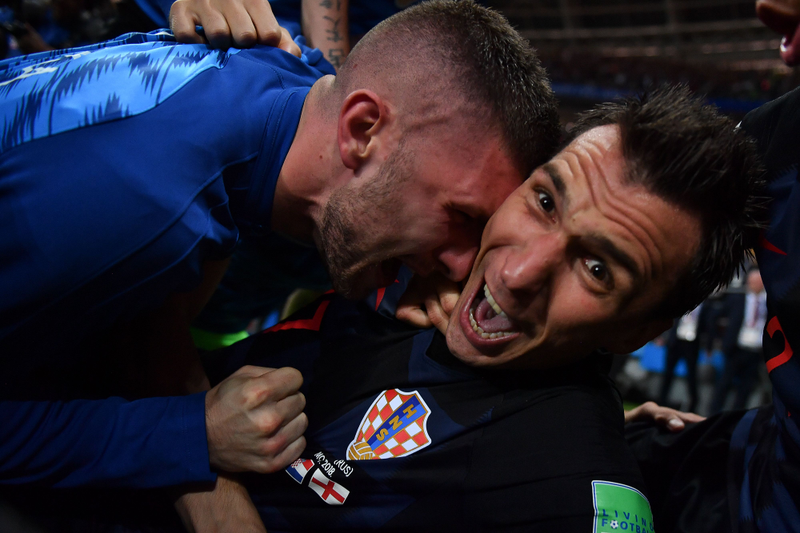Illustration for article titled Photographer Tackled By Celebrating Croatian Players Got Incredible Photos, Kisses